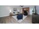 Spacious living room features fireplace, wood flooring and ceiling fan with plenty of space to relax at 415 Mission Hills Ave, Temple Terrace, FL 33617