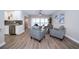 Open living room features modern gray furniture, ceiling fan, gray tiled backsplash and access to the pool at 415 Mission Hills Ave, Temple Terrace, FL 33617