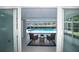 Back patio leading to screened-in pool overlooking tropical backyard at 415 Mission Hills Ave, Temple Terrace, FL 33617