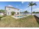 Lovely backyard features a private pool, well-maintained lawn, and a white fence at 419 Stone Briar Dr, Ruskin, FL 33570
