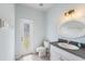 Powder room featuring an oval mirror, granite vanity and a back door to the exterior at 419 Stone Briar Dr, Ruskin, FL 33570