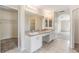 Bathroom with double vanity, tile flooring, separate walk-in shower and access to the bedroom at 419 Stone Briar Dr, Ruskin, FL 33570