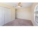 Bedroom with neutral carpet, ceiling fan and double door closet at 419 Stone Briar Dr, Ruskin, FL 33570