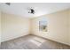 Cozy bedroom with plush carpet, a window offering outside views, and a modern ceiling fan at 419 Stone Briar Dr, Ruskin, FL 33570