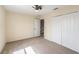 Comfortable bedroom featuring neutral walls, plush carpet, closet, and a ceiling fan at 419 Stone Briar Dr, Ruskin, FL 33570