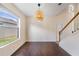 Dining area with hardwood floors, modern light fixture and large picture window at 419 Stone Briar Dr, Ruskin, FL 33570