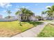 Two-story home featuring a spacious lawn, mature palms, and a two-car garage at 419 Stone Briar Dr, Ruskin, FL 33570