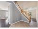 Open foyer features a staircase with a white railing, tile, and hardwood floors at 419 Stone Briar Dr, Ruskin, FL 33570