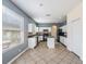 Bright kitchen with white cabinets, black appliances, and center island on ceramic tile flooring at 419 Stone Briar Dr, Ruskin, FL 33570