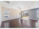 Bright living room with hardwood floors, a ceiling fan, and sliding glass doors at 419 Stone Briar Dr, Ruskin, FL 33570