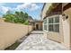 Backyard featuring tiled patio, stone walls and various lush vegetation at 4463 Vieux Carre Cir, Tampa, FL 33613