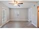 Bedroom showcasing hardwood floors, ceiling fan and access to an enclosed balcony at 4463 Vieux Carre Cir, Tampa, FL 33613