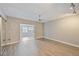 Bright bedroom with wood-look tile flooring, ceiling fan, and adjacent sunroom at 4463 Vieux Carre Cir, Tampa, FL 33613