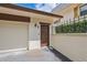 Inviting front door with a chocolate brown color, located by the garage and features an outdoor lamp at 4463 Vieux Carre Cir, Tampa, FL 33613