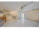 Clean two car garage, features large work area, storage shelves, and outside door at 4463 Vieux Carre Cir, Tampa, FL 33613