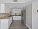 Bright kitchen with stainless steel appliances, granite countertops, tile backsplash, and white cabinets at 4463 Vieux Carre Cir, Tampa, FL 33613