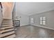 Bright living room with tiled floors, staircase, plantation shutters, and modern design, perfect for entertaining at 4463 Vieux Carre Cir, Tampa, FL 33613