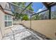 Screened in patio with pavers and stucco exterior wall, nice light and view to trees at 4463 Vieux Carre Cir, Tampa, FL 33613