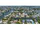 Expansive aerial view of a waterfront neighborhood with picturesque canals, docks and vibrant coastal living at 4464 Neptune Dr, Hernando Beach, FL 34607