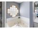 Bathroom showcasing a white bathtub with jets and glass block window for natural light at 4464 Neptune Dr, Hernando Beach, FL 34607