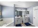 Modern bathroom with double vanities, a large soaking tub, and stylish lighting fixtures create a spa-like experience at 4464 Neptune Dr, Hernando Beach, FL 34607