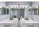 Contemporary bathroom with double sinks, elegant lighting, and modern fixtures for a functional and stylish space at 4464 Neptune Dr, Hernando Beach, FL 34607