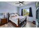 Comfortable bedroom with wood floors, a wrought iron bed, and palm tree views at 4464 Neptune Dr, Hernando Beach, FL 34607