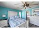 Inviting bedroom features calming turquoise walls, elegant white furniture, and a comfortable atmosphere at 4464 Neptune Dr, Hernando Beach, FL 34607