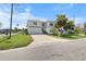 Charming two-story home with a well-kept lawn, a private driveway, and white picket fence at 4464 Neptune Dr, Hernando Beach, FL 34607