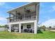 Home exterior showcasing deck with stairs, patio, and lawn at 4464 Neptune Dr, Hernando Beach, FL 34607