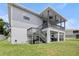 Home exterior showcasing deck with stairs, patio, and lawn at 4464 Neptune Dr, Hernando Beach, FL 34607