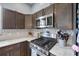 Close-up of a kitchen with stainless steel appliances, decorative tile backsplash, and gas cooktop at 4464 Neptune Dr, Hernando Beach, FL 34607