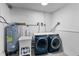Functional laundry room with modern washer, dryer, and utility sink at 4464 Neptune Dr, Hernando Beach, FL 34607