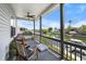 Covered patio with rocking chair overlooking a canal and waterfront neighborhood at 4464 Neptune Dr, Hernando Beach, FL 34607