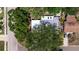 Birds-eye view of the property featuring a well maintained roof and shaded by mature trees at 4609 S Shamrock Rd, Tampa, FL 33611