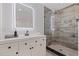 Bright bathroom with a modern vanity, black fixtures, a glass-enclosed shower with stylish tile at 4609 S Shamrock Rd, Tampa, FL 33611