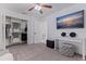 Bedroom featuring closet with storage shelves, television and carpet flooring at 4609 S Shamrock Rd, Tampa, FL 33611