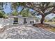 Charming single-story home boasts a paved driveway with meticulous landscaping at 4609 S Shamrock Rd, Tampa, FL 33611