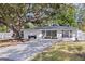Charming single-story home with a beautifully paved driveway and a large shade tree in the front yard at 4609 S Shamrock Rd, Tampa, FL 33611