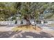 Charming single-story home with a large shade tree, paved driveway, and meticulous landscaping at 4609 S Shamrock Rd, Tampa, FL 33611