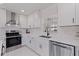 Modern kitchen featuring white cabinetry, stainless steel appliances, and sleek countertops at 4609 S Shamrock Rd, Tampa, FL 33611