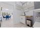 Bright laundry room with sink, storage, and view of formal dining room at 4609 S Shamrock Rd, Tampa, FL 33611