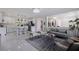 Bright, open-concept living area showcases a modern kitchen and dining area with sleek, contemporary finishes at 4609 S Shamrock Rd, Tampa, FL 33611