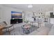 Bright, open-concept living room featuring contemporary furnishings, sleek flooring, and modern decor at 4609 S Shamrock Rd, Tampa, FL 33611
