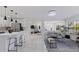 Open living space with modern lighting and marble flooring flows into a dining room and large windows at 4609 S Shamrock Rd, Tampa, FL 33611