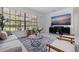 Bright living room featuring modern furnishings, a large window, and a decorative rug at 4609 S Shamrock Rd, Tampa, FL 33611