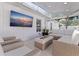 Screened in patio with white wicker furniture, TV, and overhead skylights at 4609 S Shamrock Rd, Tampa, FL 33611