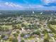 An aerial view shows Ardea Country Club and the Tennis / Pickleball / Pool location surrounded by beautiful lush trees at 465 Holly Hill Rd, Oldsmar, FL 34677
