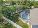 Aerial view of a private backyard with a screened pool and fenced yard with mature landscaping at 465 Holly Hill Rd, Oldsmar, FL 34677