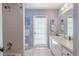 Bright bathroom with blue walls, walk-in shower, and access door to outside at 465 Holly Hill Rd, Oldsmar, FL 34677